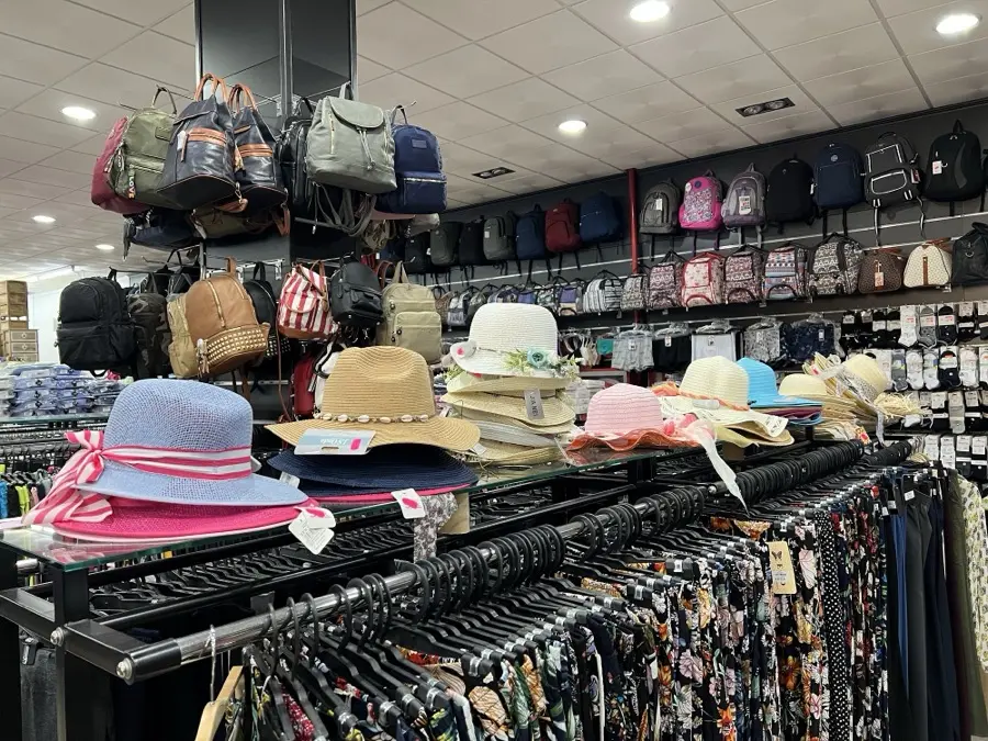 Mochilas, sombreros y ropa en la tienda